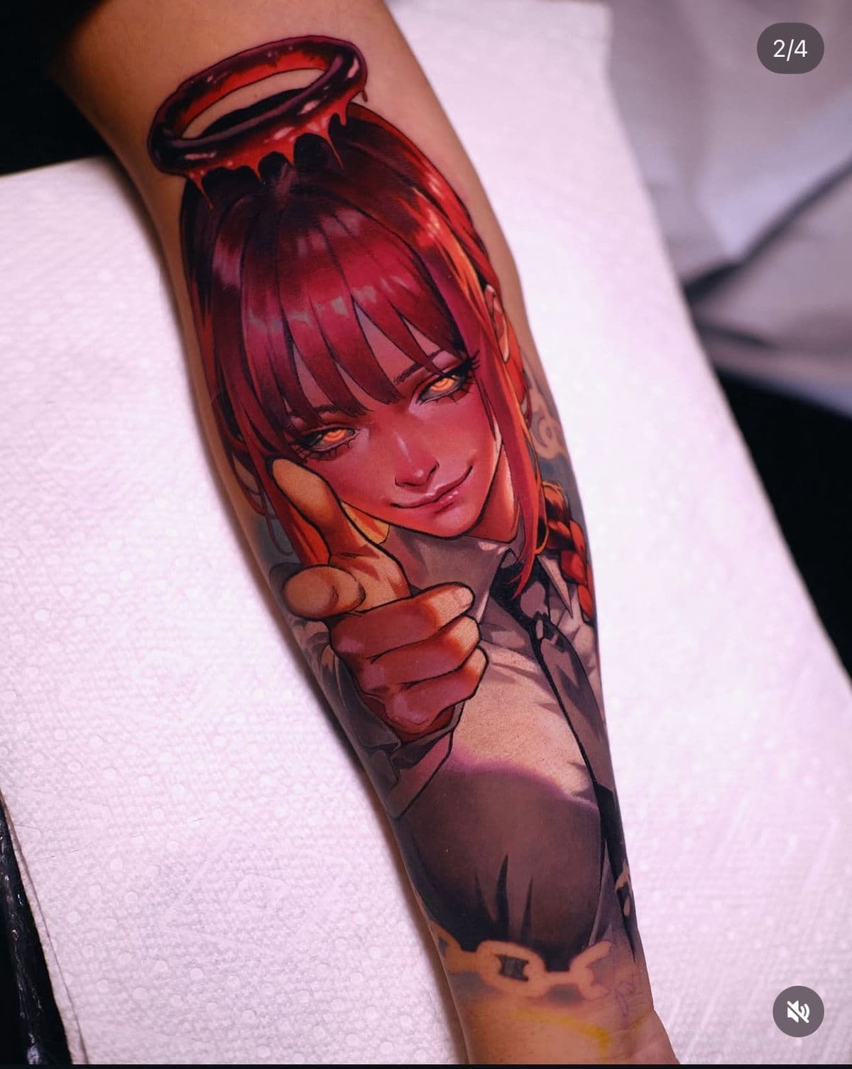 Color anime portrait tattoo of a red-haired character on a forearm